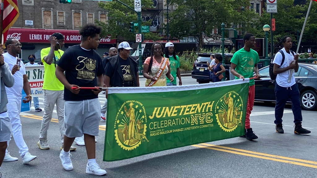 The Juneteenth flag flies alongside the Texas and United States flags